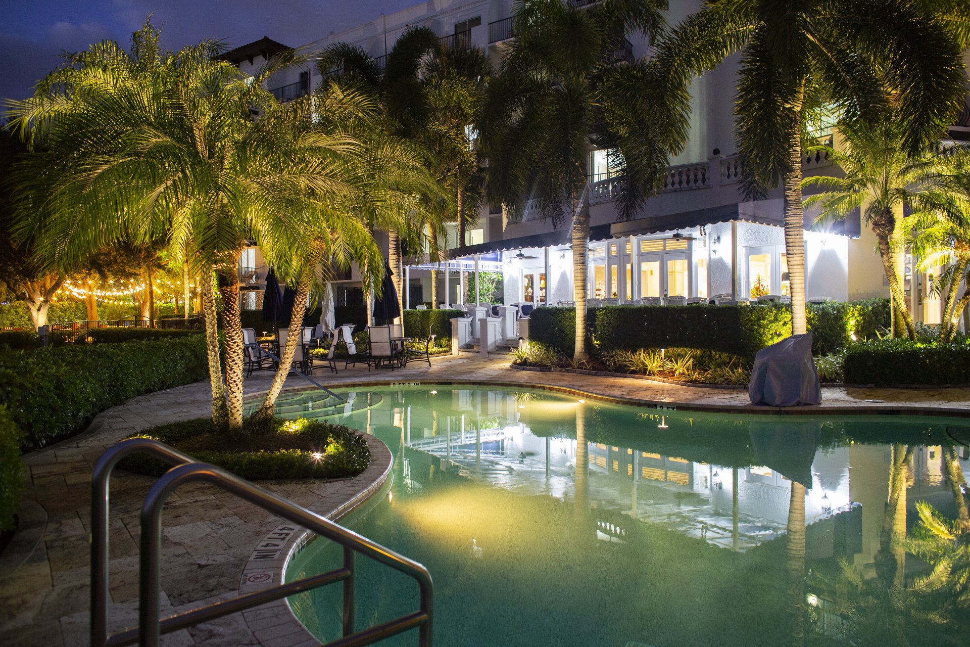 Pool and veranda at twilight, Inn at Pelican Bay